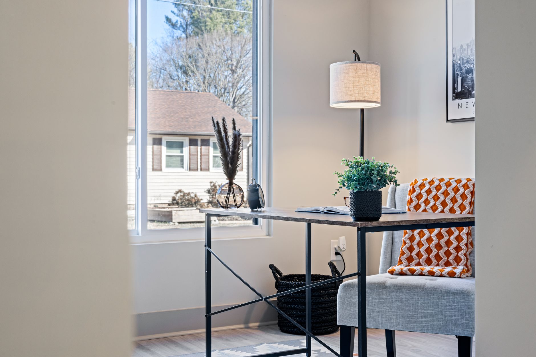 A desk beside a window with daylight coming in from the side